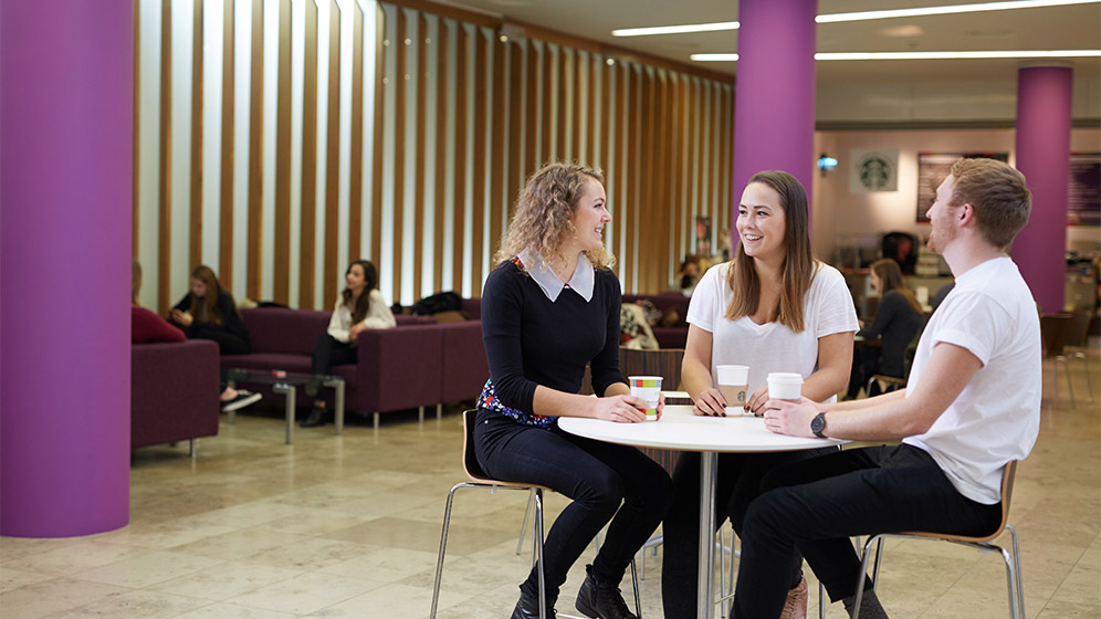 Students sat in the foyer of the Newcastle University Business School